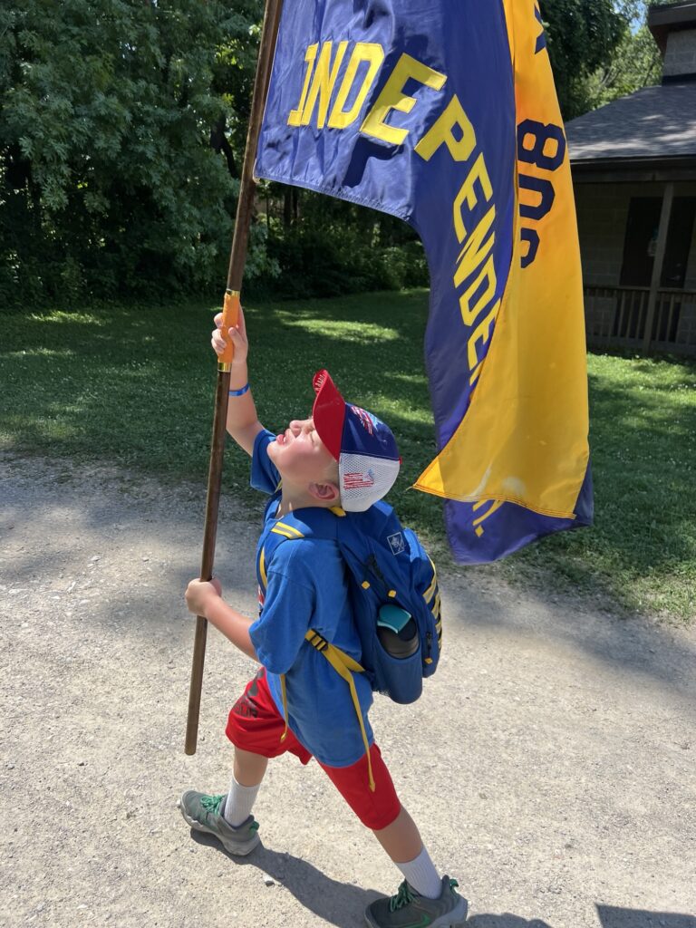 Carrying The Flag At Cub World